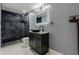 Modern bathroom features dark marble shower, bowl sink, granite countertop, and stylish vanity at 6402 Wauconda Dr, Larkspur, CO 80118