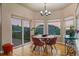 Bright breakfast nook with hardwood floors and stunning views of the surrounding landscape through large windows at 6402 Wauconda Dr, Larkspur, CO 80118