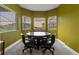 Bright dining area features a round table and charming windows that offer beautiful views of the surrounding area at 6402 Wauconda Dr, Larkspur, CO 80118
