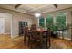 Elegant dining room with coffered ceilings, hardwood floors, and large windows providing natural light at 6402 Wauconda Dr, Larkspur, CO 80118