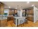 Well-equipped kitchen with stainless appliances, an island with seating, and hardwood floors at 6402 Wauconda Dr, Larkspur, CO 80118