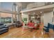 A spacious living room with hardwood floors, and many windows providing natural light at 6402 Wauconda Dr, Larkspur, CO 80118