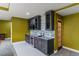 Basement wet bar features gray cabinetry, granite countertop and a wine fridge at 6402 Wauconda Dr, Larkspur, CO 80118
