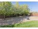 Well maintained backyard with mature trees and decorative rock features at 2 Larkdale Dr, Littleton, CO 80123