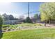 Lush backyard with mature trees, gravel accents, and a well-maintained fence line at 2 Larkdale Dr, Littleton, CO 80123