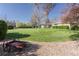 Expansive backyard with a pristine lawn and a decorative wagon feature at 2 Larkdale Dr, Littleton, CO 80123