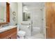 Modern bathroom with a glass-enclosed shower, granite vanity, and sleek fixtures at 2 Larkdale Dr, Littleton, CO 80123