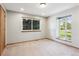 Bright bedroom features neutral walls, carpet, and well-lit windows offering lovely outdoor views at 2 Larkdale Dr, Littleton, CO 80123