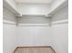 View of an empty closet with carpet flooring and multiple bars for optimal storage space at 2 Larkdale Dr, Littleton, CO 80123