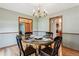Formal dining room with stylish chandelier, hardwood floors and connections to other rooms at 2 Larkdale Dr, Littleton, CO 80123