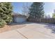 Long, flat driveway leading to a two-car garage, with mature evergreens nearby at 2 Larkdale Dr, Littleton, CO 80123