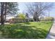 Attractive brick home with lush front lawn, mature trees and landscaping providing curb appeal at 2 Larkdale Dr, Littleton, CO 80123