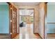 Inviting entryway with hardwood floors leading to a living area featuring skylights and sliding doors at 2 Larkdale Dr, Littleton, CO 80123