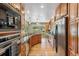 Bright kitchen with wood cabinets, stainless steel appliances, and views of the backyard at 2 Larkdale Dr, Littleton, CO 80123