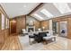 Cozy living room featuring skylights, fireplace, hardwood floors, wood paneling and comfortable seating at 2 Larkdale Dr, Littleton, CO 80123