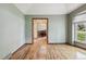 Open room with hardwood floors, neutral paint and bright window at 2 Larkdale Dr, Littleton, CO 80123