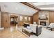 Inviting living room features a brick fireplace, wood paneled walls, and skylight for natural light at 2 Larkdale Dr, Littleton, CO 80123