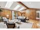 Bright living room with hardwood floors, skylights, wood paneling, fireplace and sliding glass door at 2 Larkdale Dr, Littleton, CO 80123