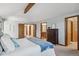Cozy main bedroom boasts a vaulted ceiling, a dresser, and an ensuite bathroom at 2 Larkdale Dr, Littleton, CO 80123