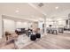 Spacious finished basement with a cozy seating area and modern kitchen with stainless steel appliances at 5983 Fulton St, Denver, CO 80238