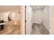 Finished basement with wood flooring and adjacent utility room at 5983 Fulton St, Denver, CO 80238
