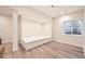 Finished basement with built-in seating and wood laminate flooring offers a flexible living space at 5983 Fulton St, Denver, CO 80238