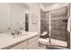 Modern bathroom with a tiled shower, a glass door, and a vanity with sink at 5983 Fulton St, Denver, CO 80238