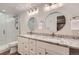 Bright bathroom boasts double sinks, granite countertops, and sleek glass-enclosed shower at 5983 Fulton St, Denver, CO 80238