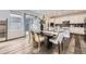 Open-concept dining area with modern lighting, seamless access to the kitchen and patio at 5983 Fulton St, Denver, CO 80238
