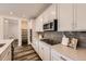 Modern kitchen with quartz counters, gray backsplash, and stainless steel appliances at 5983 Fulton St, Denver, CO 80238