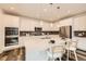 Bright, modern kitchen features a large island with bar seating and stainless steel appliances at 5983 Fulton St, Denver, CO 80238