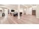 Open-concept living space showcasing hardwood floors, modern lighting, and seamless flow to the kitchen at 5983 Fulton St, Denver, CO 80238