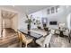 Spacious living area with dining, fireplace, and view of soaring ceilings and natural light at 5983 Fulton St, Denver, CO 80238