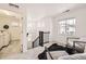 Bright loft area featuring neutral decor, plush rug, and convenient access to the laundry room at 5983 Fulton St, Denver, CO 80238