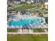 Aerial view of a community pool with water slides, seating and a area at 5983 Fulton St, Denver, CO 80238