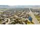Expansive aerial view of a residential community with mountain views, a central pond, and easy access to a main thoroughfare at 6378 Noble Ct, Arvada, CO 80403