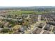 Lush neighborhood aerial view with houses near a lake, mature trees, and ample greenery at 6378 Noble Ct, Arvada, CO 80403