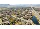 Wide aerial perspective capturing homes, trees, and a scenic landscape with a lake in the distance at 6378 Noble Ct, Arvada, CO 80403