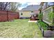 Spacious backyard featuring a well-maintained lawn, a small wooden deck, and brick garden beds at 6378 Noble Ct, Arvada, CO 80403