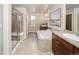 Elegant bathroom featuring a walk-in shower, soaking tub, and dual sinks at 6378 Noble Ct, Arvada, CO 80403