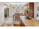 Bright dining area with modern light fixtures and adjacent access to a private balcony at 6378 Noble Ct, Arvada, CO 80403