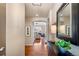Inviting foyer with hardwood floors leading to a bright living room with a fireplace at 6378 Noble Ct, Arvada, CO 80403