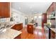 Spacious kitchen featuring granite countertops, stainless steel appliances, and hardwood flooring at 6378 Noble Ct, Arvada, CO 80403
