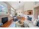 Open-concept living room featuring fireplace, cathedral ceilings and hardwood floors throughout at 6378 Noble Ct, Arvada, CO 80403