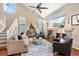 Inviting living room features a fireplace, large windows, and comfortable seating for entertaining at 6378 Noble Ct, Arvada, CO 80403