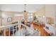 Open-concept living space with fireplace, dining area, and abundant natural light at 6378 Noble Ct, Arvada, CO 80403