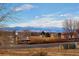 Community view with mountain views in winter at 6891 Longpark Dr, Parker, CO 80138