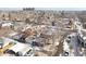 Aerial view of a neighborhood with single Gathering homes, tree coverage and buildings in the distance at 725 E Exposition Ave, Denver, CO 80209