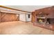Spacious basement featuring a brick fireplace and tile flooring at 2743 S Reading Ct, Denver, CO 80231