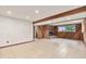 Finished basement with cozy brick fireplace, wood paneling, and tiled floors at 2743 S Reading Ct, Denver, CO 80231